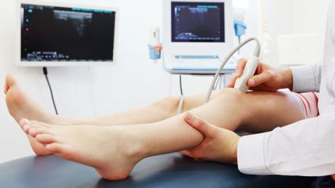 A person getting a doppler done on their leg